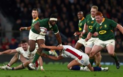 South Africa's Siya Kolisi avoids a tackle from England fly-half Marcus Smith at Twickenham in 2021