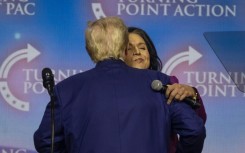 US President-elect Donald Trump embraces former US Representative Tulsi Gabbard, whom he has tapped for a top intelligence role 