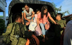 The military helped evacuate villagers from areas threatened by Typhoon Man-Yi