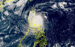 A Himawari satellite handout photo from the Japan Meteorological Agency website shows Super Typhoon Man-yi making landfall on the island of Luzon in the Philippines