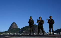 Brazilian army soldiers stand guard on Botafogo beach with the Sugar Loaf mountain in the background during the G20 Summit in Rio de Janeiro