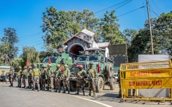 Army personnel stand guard Tuesday during a curfew in Imphal, in India's northeastern state of Manipur