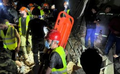 Members of the Lebanese emergency services works at the site of an Israeli strike that targeted Zuqaq al-Blat neighbourhood in Beirut