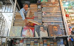 Royal Music Collection store owner Abdul Razzak arranges vinyl records at his shop in Mumbai