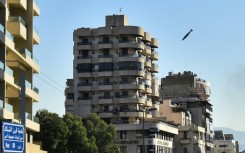 An Israeli missile is about to hit a building in Beirut's southern Shiyah neighbourhood, sparking a fireball and collapsing the structure onto itself