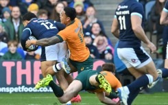 Key score: Scotland's captain Sione Tuipulotu (L) runs to the line to score the first try of a one-off Test against Australia at Murrayfield