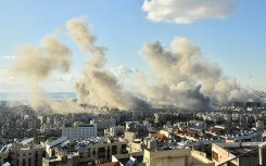 Smoke billows above Beirut's southern suburbs during a spate of Israeli air strikes on Tuesday