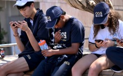 Students look at their phones in Australia, where the government has passed a law banning social media for those under 16