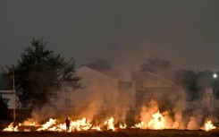 Burning straw stubble, a common but illegal practice in India, sends acrid smoke drifting over the country's densely populated north