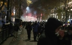 Protesters in Georgia shoot fireworks as riot police create barricade