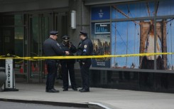 Outside the hotel senior police commanders briefed officers, as plainclothes detectives passed by upturned paper cups marking evidence