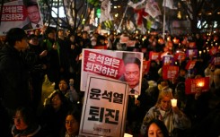 People take part in a candlelight vigil calling for the resignation of South Korean President Yoon Suk Yeol 