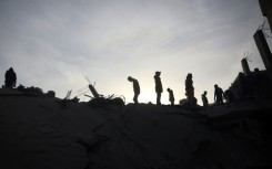 Palestinians inspect damage after an Israeli strike on Nuseirat refugee Camp, central Gaza, as mediator Qatar sees 'momentum' returning to talks on a Gaza truce and hostage release deal