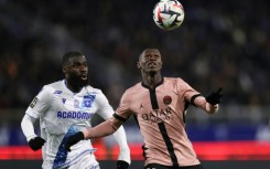 Paris Saint-Germain's Nuno Mendes (R) holds off Lassine Sinayoko of Auxerre during Friday's goalless draw in Ligue 1