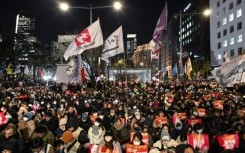 On Friday night, at least 15,000 anti-Yoon protesters braved the cold weather to gather outside the National Assembly 