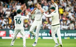 Australian captain Pat Cummins (C) celebrates after taking the wicket of India's KL Rahul