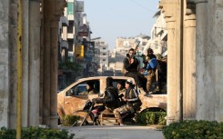 Rebel forces patrol the streets of Hama