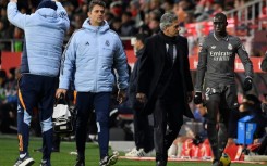 Real Madrid's French defender Ferland Mendy (R) leaves the pitch after an injury against Girona