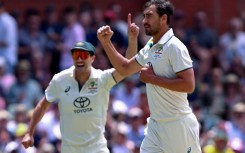 Australia's Mitchell Starc (R) and captain Pat Cummins celebrate another Indian wicket