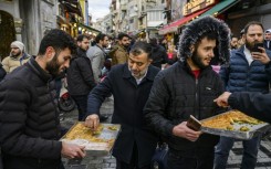 Syrians hand out baklavas in Istanbul to celebrate the reported fall of President Bashar al-Assad