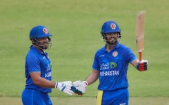 Darwish Rasooli (R) celebrates with Gulbadin Naib after scoring his first fifty for Afghanistan in a Twenty20 international against Zimbabwe in Harare on December 13.
