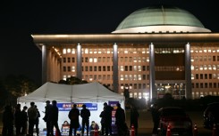 Demonstrators take part in a sit-in protest calling for the ouster of South Korea President Yoon Suk Yeol on the grounds of the National Assembly in Seoul 