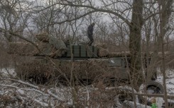 A Ukrainian tank crew member of the 68th Jaeger Brigade stands on a Leopard 1A5 tank near Pokrovsk