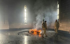 Rebel fighters set fire to the tomb of Assad's father and predecessor Hafez in their home village of Qardaha