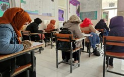 Afghan students take a test at an institute of health sciences in Ghazni