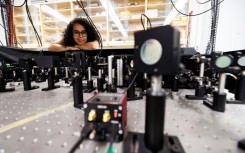 Experimental physicist Daniela Angulo poses with an apparatus in the physics lab at the University of Toronto