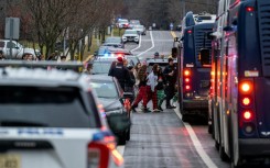 Students are escorted to a bus so they can be reunited with their parents after a deadly school shooting in Madison, Wisconsin on December 16, 2024 