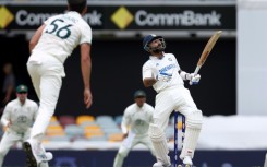 India's Virat Kohli (R) faces a bouncer from Australia's Mitchell Starc