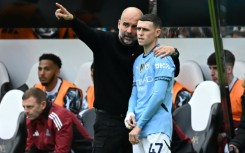 Manchester City manager Pep Guardiola speaks with Phil Foden