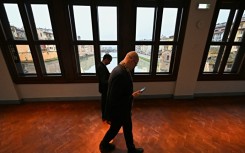 People walk in the Vasari Corridor gallery, in the center of Florence