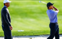 Tiger Woods, left, watches son Charlie practice ahead of the weekend's 36-hole PNC Championship for parent and child pairs