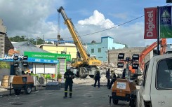 Rescue workers are seen on December 19, 2024 at a collapsed building from Vanuatu's first earthquake, in a photo taken and released by the Australian Department of Foreign Affairs and Trade