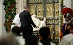 Pope Francis opens the Holy Door of St Peter's Basilica during a ceremony to mark the launch of Jubilee 2025