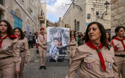 A small parade of Palestinian scouts included banners speaking out against the war in Gaza