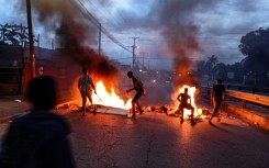 Protesters gathered next to a burning barricade in Maputo on Monday after the victory of the long-ruling Frelimo party was confirmed