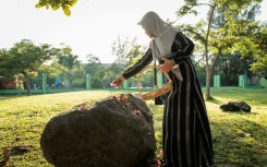 Some Indonesians sprinkled petals at mass graves in Aceh to mark the tsunami anniversary