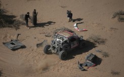 Sebastien Loeb starts rolling again after patching up his car following a crash on stage three of the Dakar Rally