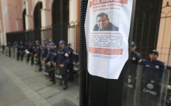 A poster asking for information on Venezuelan opposition leader Edmundo Gonzalez Urrutia is pictured in a pole amid heavy security in Caracas on January 8, 2025