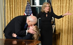 US President Joe Biden kisses his grand-son Beau Biden Jr. as First Lady Jill Biden gestures after the President delivered his farewell address to the nation from the Oval Office of the White House in Washington, DC, on January 15, 2025.