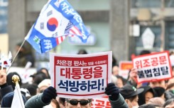 Outside the court, AFP journalists saw crowds of Yoon's backers waving flags and holding 'release the president' placards